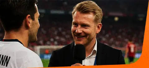 person interviewed on a football pitch